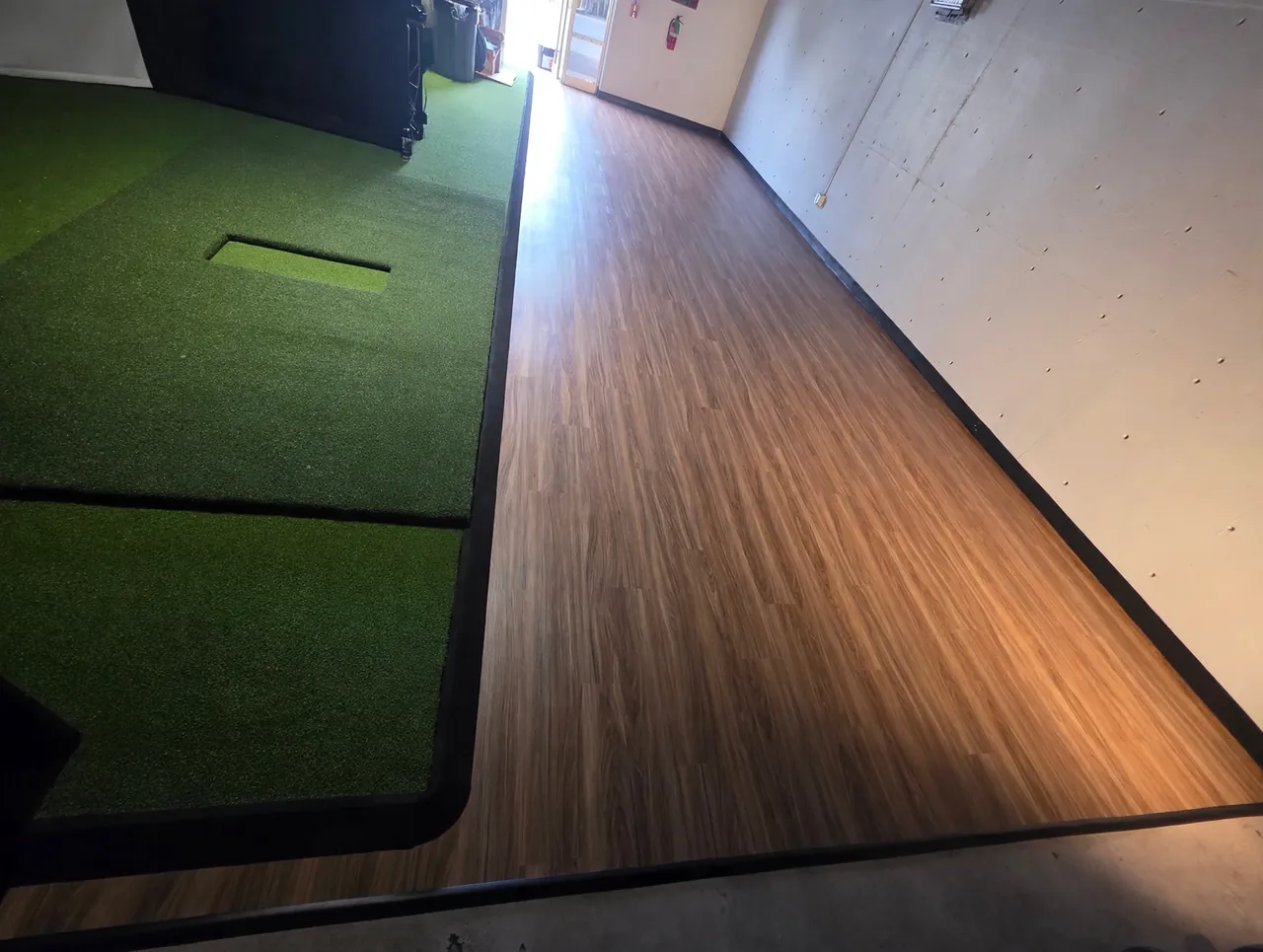 Commercial space finished with indoor turf and luxury vinyl plank flooring